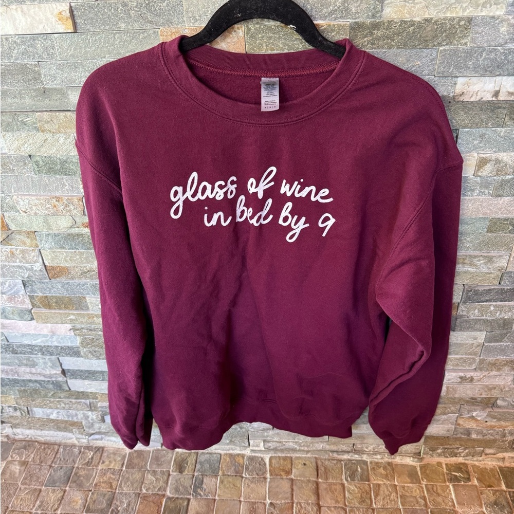 Glass of wine in bed by 9  Graphic Sweatshirt
Size medium